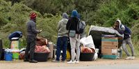 Some of the hundreds of foreign nationals waiting for transport to leave the area on 27 May. (Photo: Deon Ferreira)