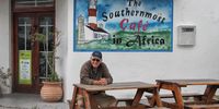 A currently more grizzled Chris Marais at a freshly-painted Southernmost Café in Africa. Photographer: Chris Marais