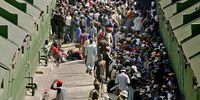 Hundreds of immigrant men on the other side of the Repatriation Tunnel at the Lindela Repatriation Centre in Krugersdorp, 24 October 2006. (Photo: Gallo Images / Media24 / Lisa Skinner)