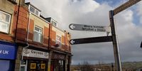A street sign in Blackwood gives directions to the miners institute and credit union. (Photo: Phil Miller)