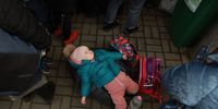 LVIV, UKRAINE - MARCH 23: Sophia, aged 1, lies on a piece of luggage as she and her mother wait for the train to Poland at the main train station on March 23, 2022 in Lviv, Ukraine. Her mother said they fled from the city of Dnipr. More than 3 million people have fled Ukraine, with millions more internally displaced, after Russia's large-scale invasion of the country on Feb. 24. (Photo by Joe Raedle/Getty Images)