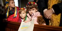 MANCHESTER, ENGLAND - FEBRUARY 24: Children wear crowns made from  flowers as members of the Manchester Ukrainian community attend morning mass at St Mary's Ukrainian Catholic Church where the congregation prayed for, and showed their support for, relatives and the people of Ukraine on February 24, 2022 in Manchester, England. Overnight, Russia launched a large-scale offensive on multiple Ukrainian cities, drawing condemnation from the British government and many allied nations. (Photo by Christopher Furlong/Getty Images)