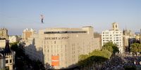 French tightrope walker Nathan Paulin walks along a 350-meters narrow cable in both directions from two buildings between the Placa Catalunya (Catalonia Square) and Passeig de Gracia (Gracia Avenue), during a show as part of the Grec Festival held in Barcelona, Spain, 02 July 2023.  EPA-EFE/Quique Garcia