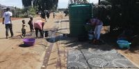 People gather to fetch cooking and washing water in Protea, Soweto last week as the water crisis in the city unfolded.(Photo: Bheki Simelane)