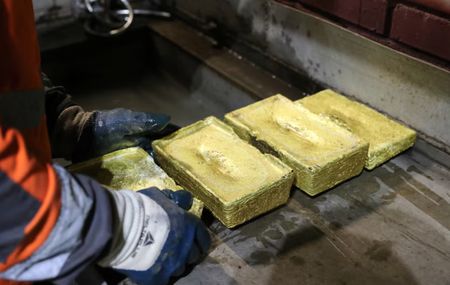 Gold gains on weaker dollar; traders brace for Fed rate decision