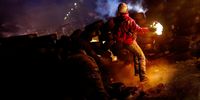 A protestor throws a molotov cocktail. Production still from "Winter On Fire: Ukraine’s Fight For Freedom." Image:  courtesy of Netflix