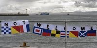 Protestors marked the Karpinsky’s April 2023 return from the Southern Ocean with flags at<br>Cape Town harbour. (Photo: Nic Bothma)