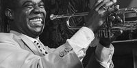 Circa 1950: Louis Armstrong plays his trumpet during a performance in Baltimore, Maryland. (Photograph by Bettmann/ Getty Images)