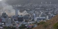 epa09663379 A general view shows smoke billowing from a building at the South African Parliament precinct in Cape Town, South Africa, 02 January 2022. Firefighters battled for hours a major fire that broke out in the South African parliament building in Cape Town on 02 January. No casualties were reported and the cause of the blaze was not yet known.  EPA-EFE/STRINGER