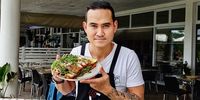 Goo Imthawin dishes crispy pork inside the casual shared club space. (Photo: Wanda Hennig) 