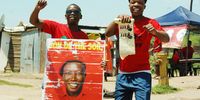 Economic Freedom Fighters supporters Thami Msomi (left) and Sbonelo Mkhize in a good mood at the ward 54 voting station in Bhambayi north of Durban near KwaMashu in KwaZulu-Natal during the local government elections on 1 November 2021. (Photo: Phumlani Thabethe)