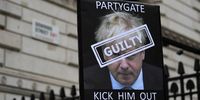 epa09887689 A protester holds up a placard of British Prime Minister Boris Johnson outside Downing Street in London, Britain, 13 April 2022. The Metropolitan Police have handed fines to British Prime Minister Boris Johnson and Chancellor Rishi Sunak over Downing Street lockdown party breaches. The Labour Party are calling for Johnson and Sunak to resign.  EPA-EFE/ANDY RAIN