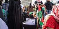 A woman raises her fist in solidarity with Palestine during a protest outside Parliament in Cape Town, on Wednesday, 12 May 2021. (Photo: Victoria O’Regan)
