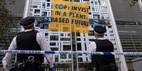 LONDON, ENGLAND - OCTOBER 26: Police move in to cut down a banner as Environmental activists remain at the Home Office on October 26, 2021 in London, England. Protesters dropped a banner from the building reading "COP: Invest In A Plant-Based Future," referring to the upcoming United Nations Conference On Climate Change (COP26) in Glasgow that starts this weekend. (Photo by Dan Kitwood/Getty Images)