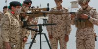 King Hamad of Bahrain (left) inspects a British-made sniper rifle on Monday. (Photo: Bahrain News Agency)