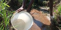 Resident collects water from an unclean water source, the community hasn't had water for 5 months but the issue goes back over a decade. KwaZulu- Natal.<br>(Photo: Naledi Sikhakhane)