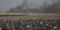 epa06736295 Hundreds of Palestinian protesters gather during clashes after protests near the border with Israel in the east of Gaza Strip, 14 May 2018. According to media reports, at least 50 Palestinians were killed and more than 1800 wounded during clashes in Gaza-Israeli border during clashes against the US embassy move to Jerusalem as well as marking Nakba Day. Palestinians are marking the Nakba Day, or the day of the disaster, when more than 700 thousand Palestinians were forcefully expelled from their villages during the war that led to the creation of the state of Israel on 15 May 1948. Protesters call for the right of Palestinians to return to their homeland.  EPA-EFE/MOHAMMED SABER