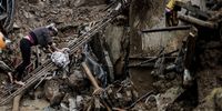 epaselect epa09763778 A woman tries to walk on the rubble left by heavy rains, in Petropolis, Brazil, 16 February 2022. Petropolis was devastated by the rains that have left more than fifty dead, thousands of homeless people and an unknown number of disappeared.  EPA-EFE/Antonio Lacerda