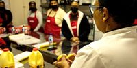 Professional pastry chef Carol Van den Horst showing women at the workshop how a freshly baked scone should look. (Photo: Julia Evans)