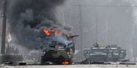 This photograph taken on February 27, 2022 shows a Russian Armoured personnel carrier (APC) burning next to unidentified soldier's body during fight with the Ukrainian armed forces in Kharkiv. - Ukrainian forces secured full control of Kharkiv on February 27, 2022 following street fighting with Russian troops in the country's second biggest city, the local governor said. (Photo by Sergey BOBOK / AFP) / ìThe mention [next to unidentified soldier's body] has been added to the caption and the erroneous mention[s] appearing in the metadata of this photo by Sergey BOBOK has been modified in AFP systems in the following manner: [February 27] instead of [February 26]. Please immediately remove the erroneous mention[s] from all your online services and delete it (them) from your servers. If you have been authorized by AFP to distribute it (them) to third parties, please ensure that the same actions are carried out by them. Failure to promptly comply with these instructions will entail liability on your part for any continued or post notification usage. Therefore we thank you very much for all your attention and prompt action. We are sorry for the inconvenience this notification may cause and remain at your disposal for any further information you may require.î