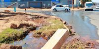 Motorists drive past leaking water along Mphuti Street on 8 July, 2021 in Soweto, South Africa. It is reported that traffic along the road has been affected for months by the leaking water and the road has potholes and garbage trapped on the side. (Photo: Gallo Images/Fani Mahuntsi)