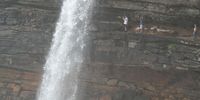 South of the Mkambati Nature Reserve, a hiker is dwarfed by a fountain of water at Waterfall Bluff. 