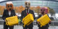GLASGOW, SCOTLAND - OCTOBER 29: Activists from Ocean Rebellion wearing Oil heads are seen pouring oil during a protest outside  SSE Hydro on October 29, 2021 in Glasgow, Scotland. COP26 will officially begin on Sunday October 31 with the procedural opening of negotiations and finish on Monday November 12th.  (Photo by Peter Summers/Getty Images)