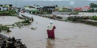 A resident attempts to cross the river at Pelem Road bridge in the Eastern Cape in 2023. More than 1,000 people were displaced by heavy flooding. (Photo: Tembile Sgqolana)