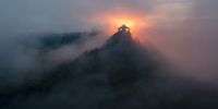 An image taken with drone shows the clouds as they float around Salgo Castle during sunset near Salgotarjan, Hungary, 30 July 2023 (issued 31 July 2023).  EPA-EFE/Peter Komka 