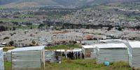 Illegal structures built on vacant land at a farm next to Kayamandi on August 06, 2018 in Stellenbosch, South Africa. The owners of the farm reportedly obtained an urgent interdict to remove unoccupied structures, and to prevent more people from moving onto a vacant portion of their property. (Photo by Gallo Images / Brenton Geach)