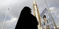 Veiled Iranian woman walks next to the Sejil surface-to-surface missile displayed at a street exhibition on the occasion of 'Defence Week', at the Baharestan Square in Tehran, Iran, 26 September 2023. Military equipment displayed by Iran's army and paramilitary Revolutionary Guard to celebrate 'Defence Week' marking the 43rd anniversary of the start of 1980-88 Iran-Iraq war.  EPA-EFE/ABEDIN TAHERKENAREH