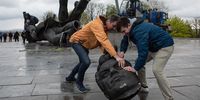KYIV, UKRAINE - APRIL 26: Two men move a head from the The 'Friendship of Peoples' monument during its demolition on April 26, 2022 in Kyiv, Ukraine. Kyiv's Mayor Vitali Klitschko announced in a social media post that the 8-meter high statue of men holding a star-shaped emblem that says "Friendship of Peoples" and "USSR" would be removed from the city, and the metal arch overhead would be renamed. (Photo by Alexey Furman/Getty Images)