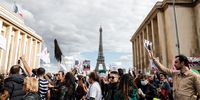 epa10206035 Demonstrators pass by in front of the Eiffel Tower during a protest march towards the Iranian Embassy in Paris, France, 25 September 2022. Under the call of several human rights organizations such as 'Licra' or France Fraternite, hundreds of people demonstrated on the November 11 square in Paris to protest against repression in Iran after the death of the Kurdish women Mahsa Amini by the moral police.  EPA-EFE/TERESA SUAREZ