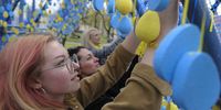 epa09891441 Ukrainians hang symbolic blue and yellow eggs at a installation called 'A life corridor' in the downtown of Western Ukrainian city of Lviv, Ukraine, 15 April 2022, to pay respect to Ukrainians who died during the Russian invasion. The painted eggs are the symbol of life, incoming Easter, and memory for people who couldn't to went the Green corridors for evacuation because they so often were shelled by Russian troops. The form of installation was made like home roofs as millions of Ukrainians were obliged to leave their homes to save themselves from the war. Russian troops entered Ukraine on 24 February resulting in fighting and destruction in the country and triggering a series of severe economic sanctions on Russia by Western countries.  EPA-EFE/MYKOLA TYS