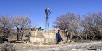 Danie Meiring, of the farm Hoogekraal the day the borehole drillers arrived to check two of his three dry boreholes. He could only afford for them to check two. This one proved to only be blocked by roots and needed flushing out. He was much relieved that they did not have to drill deeper and please that he could fill the dam and water the animals at least.<br>Willowmore Drought, Eastern Cape, 05 October 2021. (Photo: John Hogg)