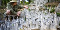 Switzerland's land art artist Francois Monthoux works on his 'Citadel of Creation', made out of clay reinforced with cement, on the forest edge in Biere, Switzerland, 20 September 2023 (issued 22 September 2023). The sculpture is still under construction. After more than 120 days of work, the sculpture measures around 4 metres high and 3 metres wide.  EPA-EFE/LAURENT GILLIERON