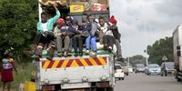 Passengers crammed at the back of a truck laden with household furniture travelling to Mutoko, as very few buses operate to ferry people due to the Covid-19 lockdown in Zimbabwe. A 30-day lockdown imposed by the government began on 5 January 2021, including a curfew between 6pm and 6am to battle the rising numbers of infections.  (Photo: EPA-EFE / Aaron Ufumeli)