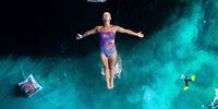 POLIGNANO A MARE, ITALY  - SEPTEMBER 25: (EDITORIAL USE ONLY) In this handout image provided by Red Bull, Rhiannan Iffland of Australia dives from the 21.5 metre platform during the first competition day of the sixth and final stop of the Red Bull Cliff Diving World Series on September 25 2021 at Polignano a Mare, Italy. (Photo by Romina Amato/Red Bull via Getty Images)