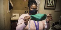 Ponani Shikweni inspects a mask. (Photo: Shiraaz Mohamed)