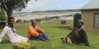 The Shongwe family, including (from left) Inkosikhona, Joseph and Rasta, used to live in the Mkhuze area but settled at the new Enkanini settlement near Dukuduku forest in 2010. Over recent years, however, their fields of potatoes, onions, cabbage and madumbes have been submerged by the frequent inundation of floodwaters in the Umfolozi River floodplain visible behind them. Picture Tony Carnie