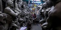 An Indian artist has lunch next to unfinished idols of Goddess Durga at Kumartuly district ahead of the Durga Puja festival in Kolkata, India, 05 August 2025. Bengalis all over the world will be marking the festival representing the victory of good over evil and the celebration of female power from 28 September to 02 October.  EPA/PIYAL ADHIKARY