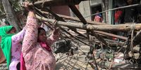 Residents look for their belongings near dismantled structures during a drive to demolish illegal structures in Delhi’s violence-hit Jahangirpuri area in New Delhi, 20 April 2022. (Photo: EPA-EFE / Rajat Gupta)