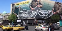 Iranians drive past a huge billboard in Tehran carrying a sentence reading in Persian, ‘The Strait of Hormuz remains closed’, on 22 April. (Photo: Abedin Taherkenareh / EPA)