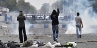 A protester flashes the victory sign at the Bahraini security services during clashes in Saar village, northwest of Manama, 14 February 2015. (Photo: EPA /Mazen Mahdi)