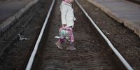 ZAHONY, HUNGARY - MARCH 08: A young refugee girl fleeing Ukraine walks across the tracks as she arrives at the border train station of Zahony on March 08, 2022 in Zahony, Hungary. More than 2 million refugees have fled Ukraine since the start of Russia's military offensive, according to the UN. Hungary, one of Ukraine's neighbouring countries, has welcomed more than 144,000 refugees fleeing Ukraine after Russia began a large-scale attack on Ukraine on February 24. (Photo by Christopher Furlong/Getty Images)
