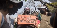 Activists stand outside the Department of Mineral Resources, Pretoria where a memorandum was handed over. The memorandum also expressed concern at President Ramaphosa's promotion of oil, coal and fossil gas that is threatening South Africa's economic growth, job creation, stable and affordable electricity and social and eco logical well being.<br>Photo / Shiraaz Mohamed.