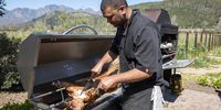 Chef Brent Malander slices meat from the lamb which he bastes with a mixture of olive oil, infused with rosemary, garlic, barbecue spices and lemon juice. (Photo: Patrick Heathcock)