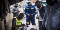 Machack Ngwenya records the details of passengers at a makeshift booking centre. (Photo: Shiraaz Mohamed)