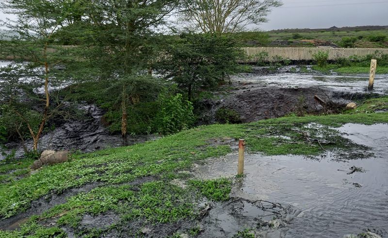 River turns black after coal mine dam collapse next to rural community ...