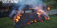 PAHOA, HAWAII - OCTOBER 28:  In this handout provided by the U.S. Geological Survey (USGS), A portion of the front of the June 27th lava flow pushes through a fence marking a property boundary on October 28, 2014 in Pahoa, Hawaii. Scientists of the Hawaiian Volcano Observatory conducted ground and air observations of the lava flow from the Kilauea Volcano and determined that it was 510 meters (560 yards) upslope from Pa-hoa Village Road and the flow width was about 50 meters (55 yards) at the leading edge. Molten rock from the flow is inching its way towards homes in the town of Pahoa on Hawaii's Big Island where close to a thousand people live.  (Photo by USGS via Getty Images)